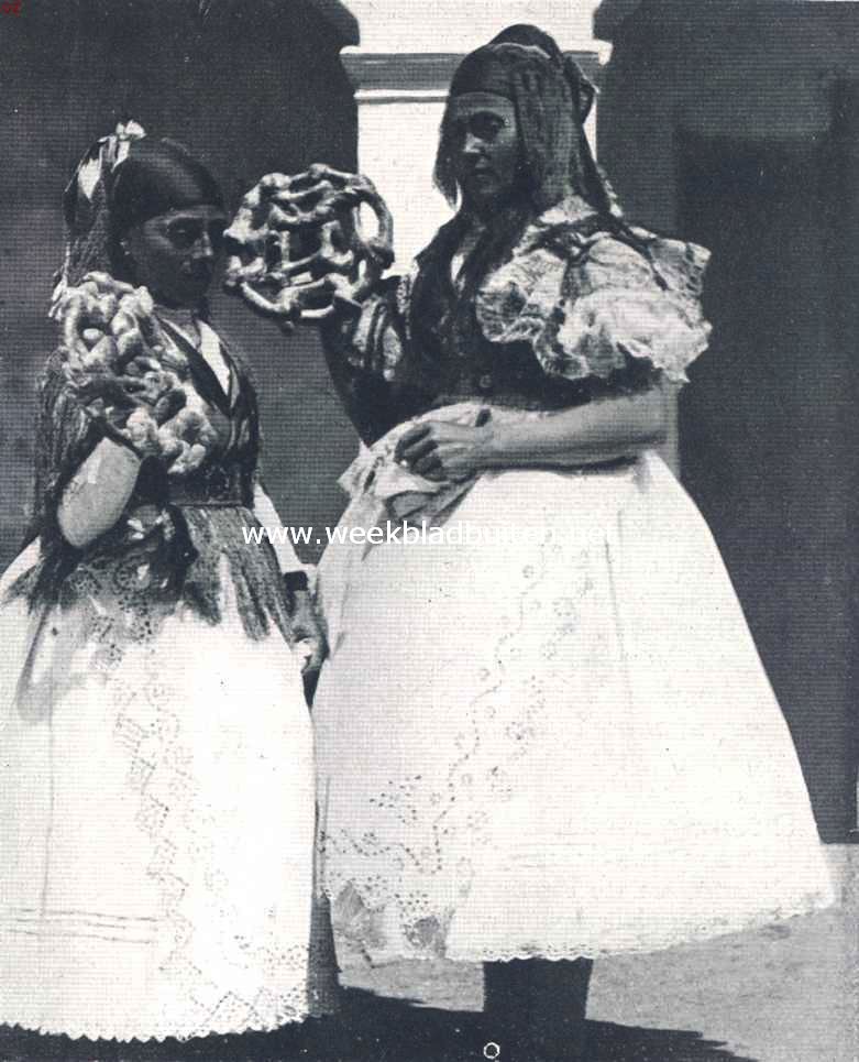 In Oost- en West-Hongarije. Vrouwen te Kapuv�r, bij een huwelijk koeken naar de toeschouwers werpend